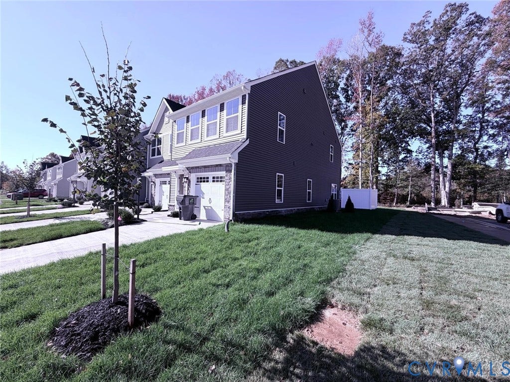 10600 Pink lily Lane, Chesterfield, VA 23234 Multi-story residence featuring horizontal siding, stone veneer accents, a paved driveway, and an attached garage
