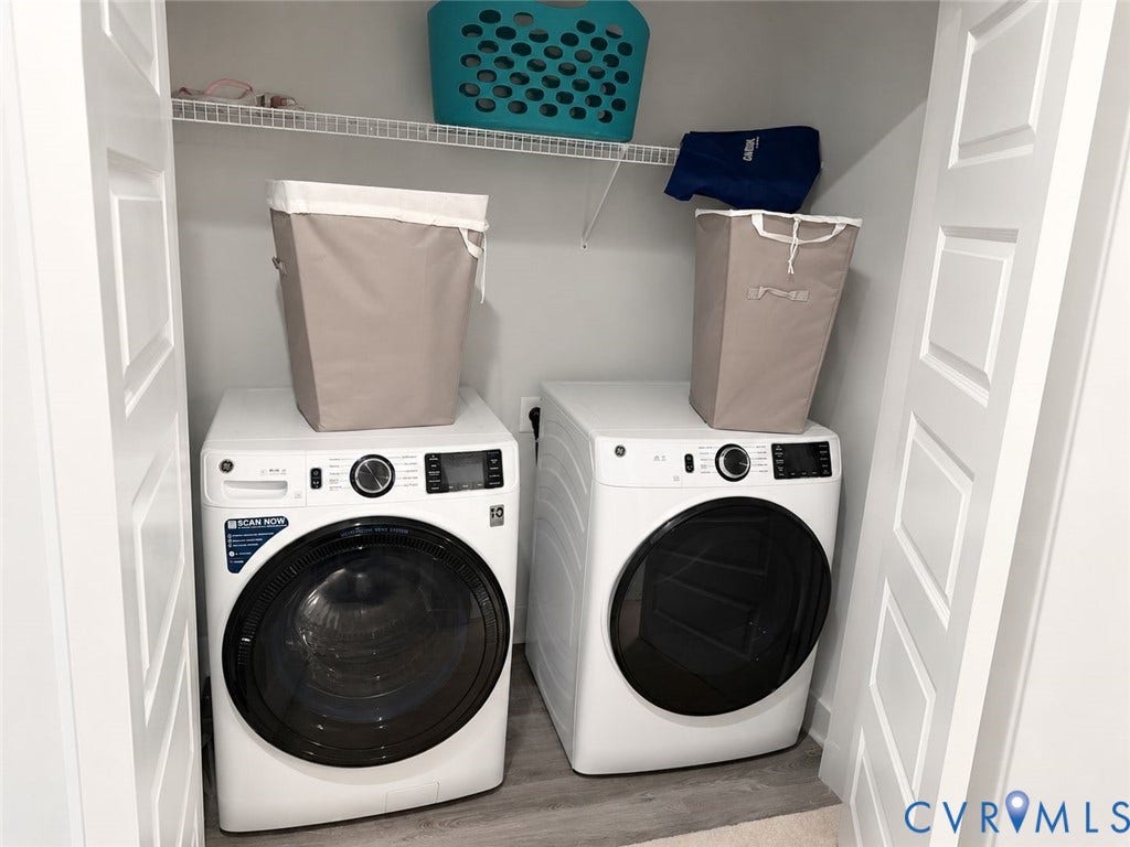 4411 GREYBULL Walk, #B, Glen Allen, VA 23233 Laundry closet featuring dual white front-load appliances and overhead wire shelving, framed by white paneled doors