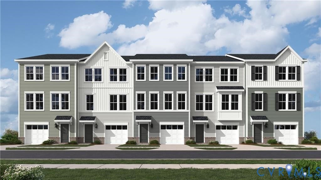 16005 Abelson Way, Chesterfield, VA 23832 Three-story townhome exterior featuring multi-toned horizontal siding, vertical board-and-batten accents, gabled rooflines, bay windows, and private attached garages
