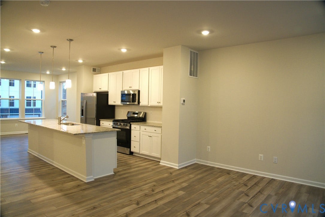 16005 Abelson Way, Chesterfield, VA 23832 Kitchen featuring white cabinetry, stone-finish countertops, stainless steel appliances, a center island with an integrated sink, and wood-finish flooring