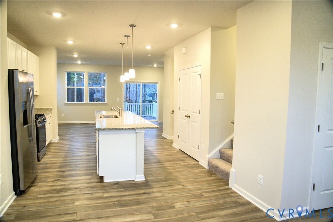 16005 Abelson Way, Chesterfield, VA 23832 Kitchen featuring wood-finish flooring, a central island with stone-surface countertops, recessed lighting, pendant light fixtures, and stainless steel appliances
