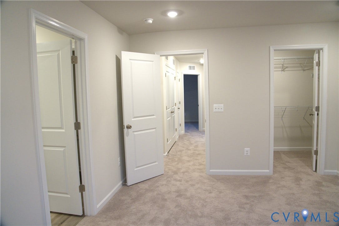 16005 Abelson Way, Chesterfield, VA 23832 Interior space featuring neutral-toned carpeting, two-panel interior doors, and a walk-in closet with built-in wire shelving