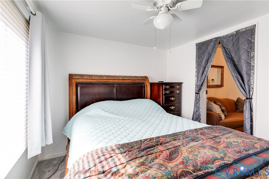 1406 Wentbridge Road, Richmond, VA 23227 Bedroom featuring a white ceiling-mounted fan with integrated light, pleated window coverings, and neutral wall tones