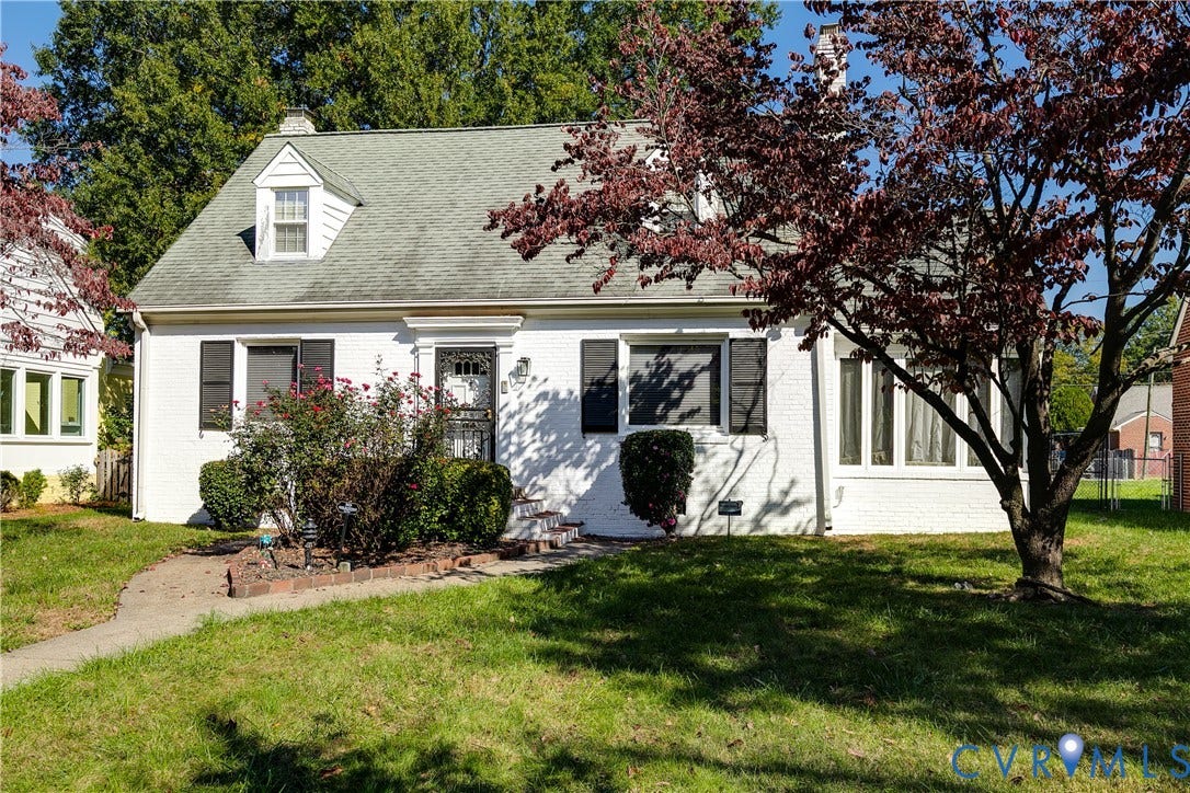 1406 Wentbridge Road, Richmond, VA 23227 Cape Cod exterior featuring painted brick masonry, a dormer window, louvered shutters, and an attached side sunroom