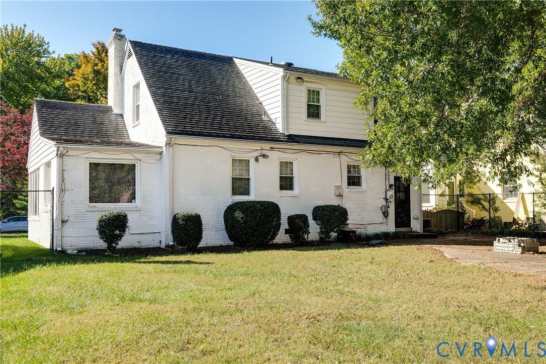 1406 Wentbridge Road, Richmond, VA 23227 Painted brick exterior, multi-level roofline, vertical siding, chimney, and stone-paved patio area