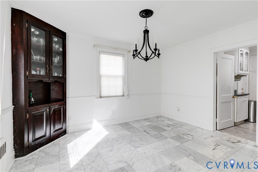 1406 Wentbridge Road, Richmond, VA 23227 Built-in dark wood hutch, stone tile flooring, traditional black metal chandelier, and chair rail molding