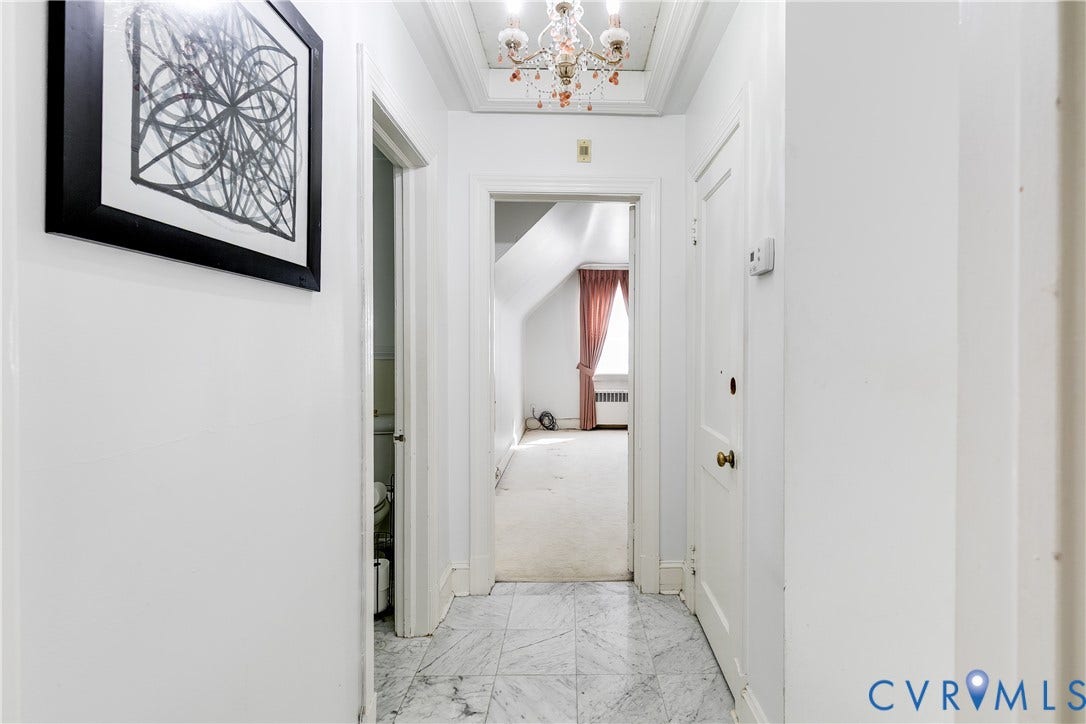 1406 Wentbridge Road, Richmond, VA 23227 Hallway featuring marble tile flooring, a multi-tiered ceiling-mounted chandelier, and recessed ceiling detail
