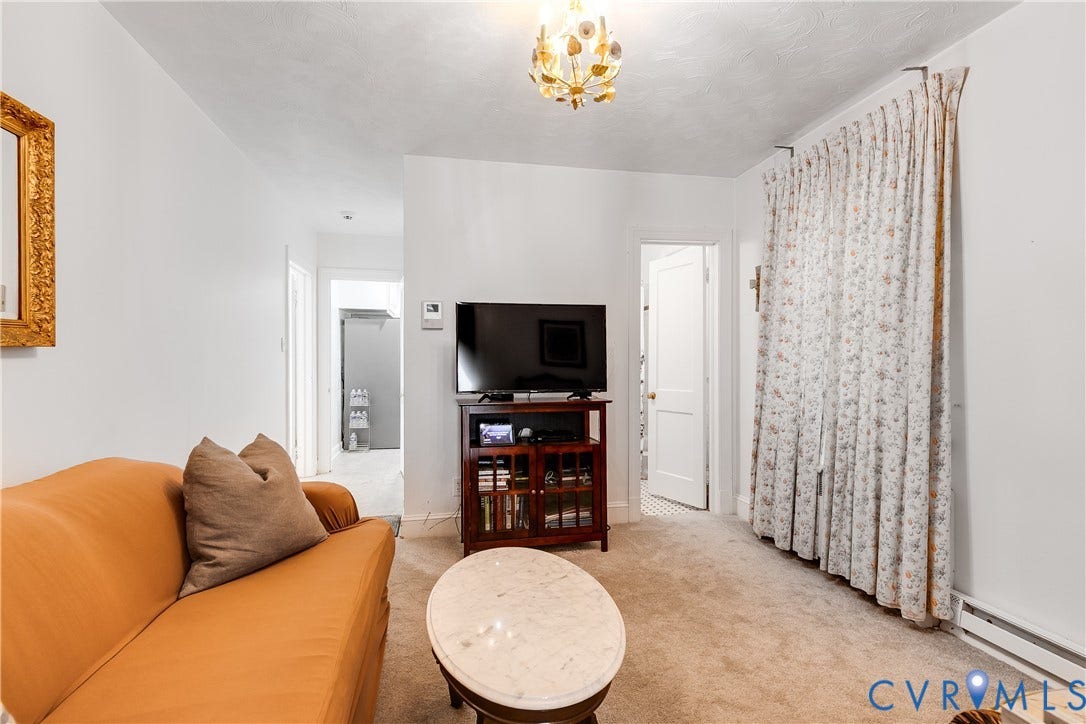 1406 Wentbridge Road, Richmond, VA 23227 Interior room featuring neutral wall-to-wall carpeting and an ornate, multi-bulb gold-tone chandelier