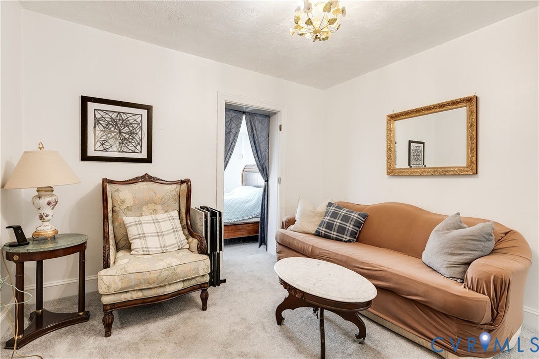 1406 Wentbridge Road, Richmond, VA 23227 Interior space featuring neutral wall tones, carpeted flooring, and a decorative multi-bulb ceiling fixture