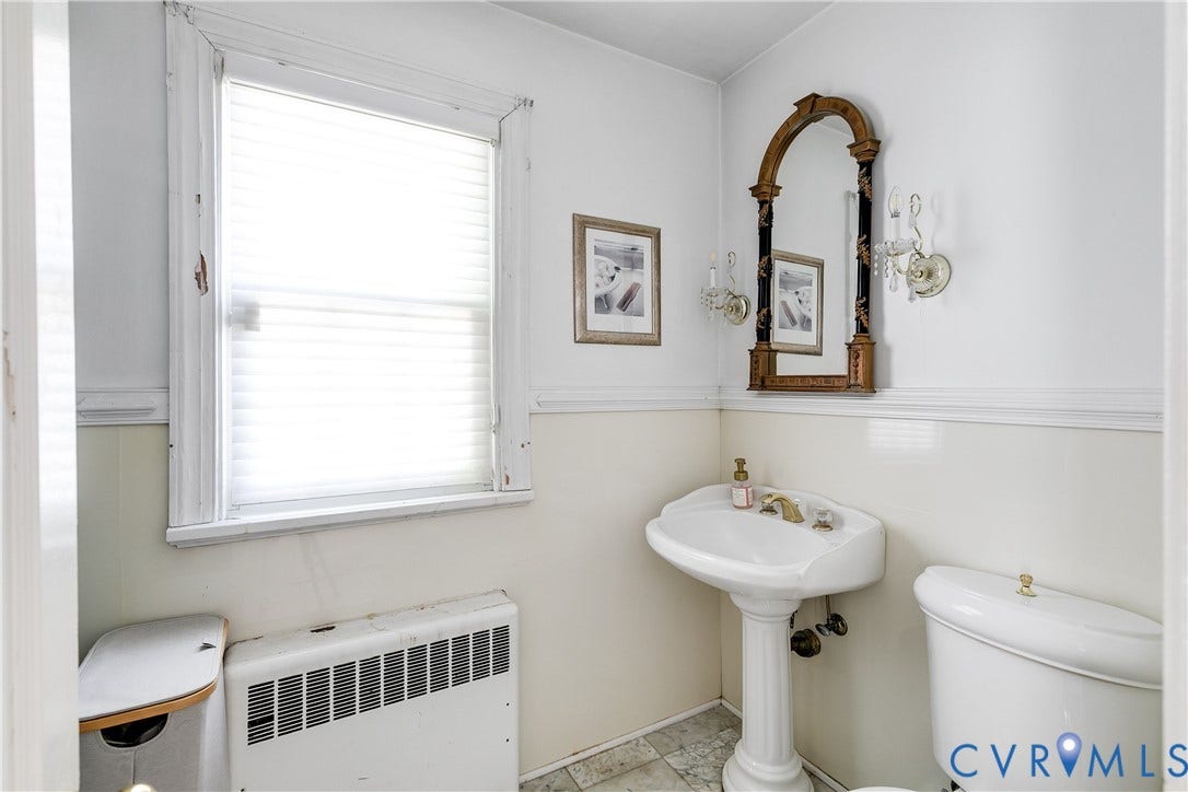1406 Wentbridge Road, Richmond, VA 23227 Bathroom featuring a pedestal sink, wall-mounted light fixtures, tile wainscoting, and tile flooring