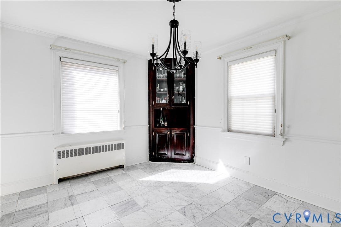 1406 Wentbridge Road, Richmond, VA 23227 Built-in corner cabinetry, stone-finish tile flooring, decorative chandelier, and wall wainscoting
