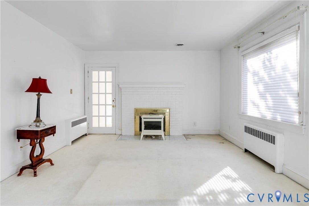 1406 Wentbridge Road, Richmond, VA 23227 Interior space featuring a white painted brick fireplace with a metallic surround, a multi-lite glass panel door, and large windows with blinds