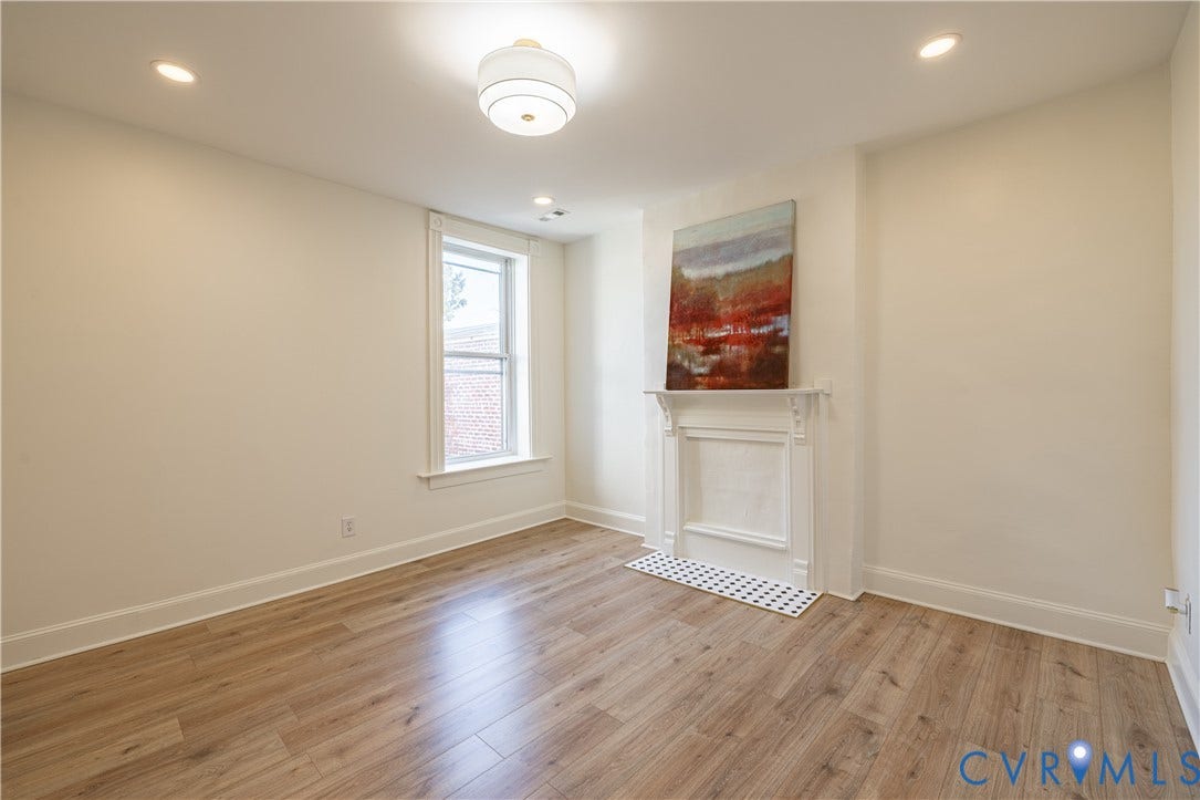 1108 W Marshall Street, Richmond, VA 23220 Interior space featuring wood-finish flooring, a decorative fireplace mantel, recessed lighting, and a modern semi-flush mount ceiling fixture