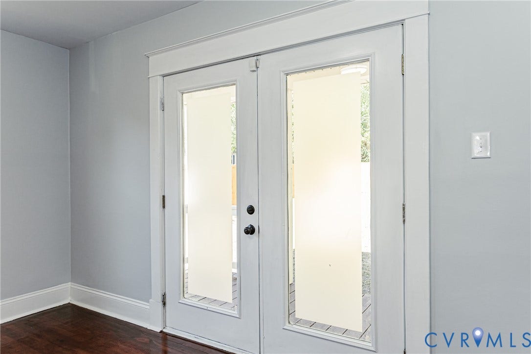 710 La Von Drive, Henrico, VA 23227 Double glass-paneled entry doors featuring white casing, dark hardware, and wood-finish flooring