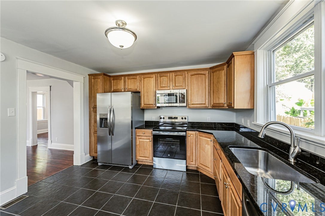 710 La Von Drive, Henrico, VA 23227 Kitchen featuring wood cabinetry, dark stone countertops, stainless steel appliances, a stainless steel undermount sink, and tiled flooring
