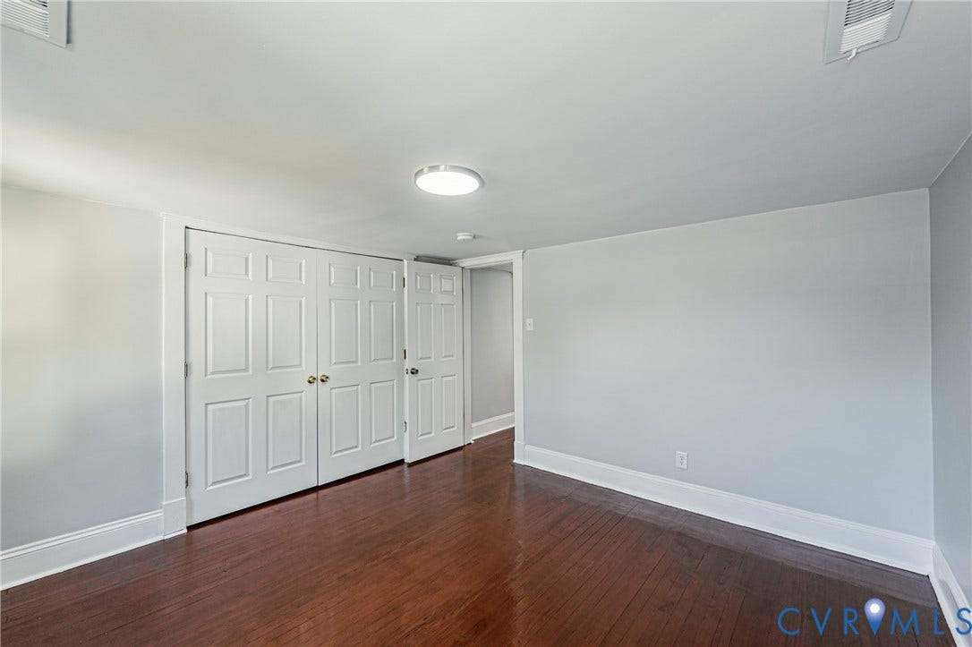 710 La Von Drive, Henrico, VA 23227 Interior room featuring wood-finish flooring, white panel doors, and a central flush-mount ceiling light