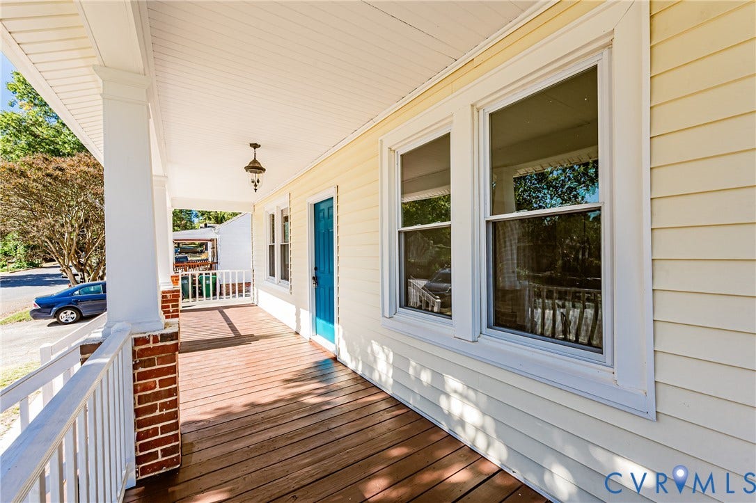 710 La Von Drive, Henrico, VA 23227 Covered front porch featuring wood-finish decking, white railings, brick-based columns, and horizontal lap siding