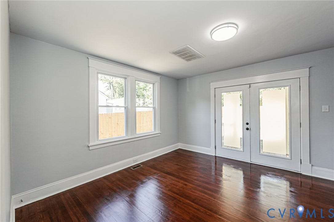 710 La Von Drive, Henrico, VA 23227 Room featuring wood-finish flooring, dual-pane windows with casing, and glass-paneled double doors with trim