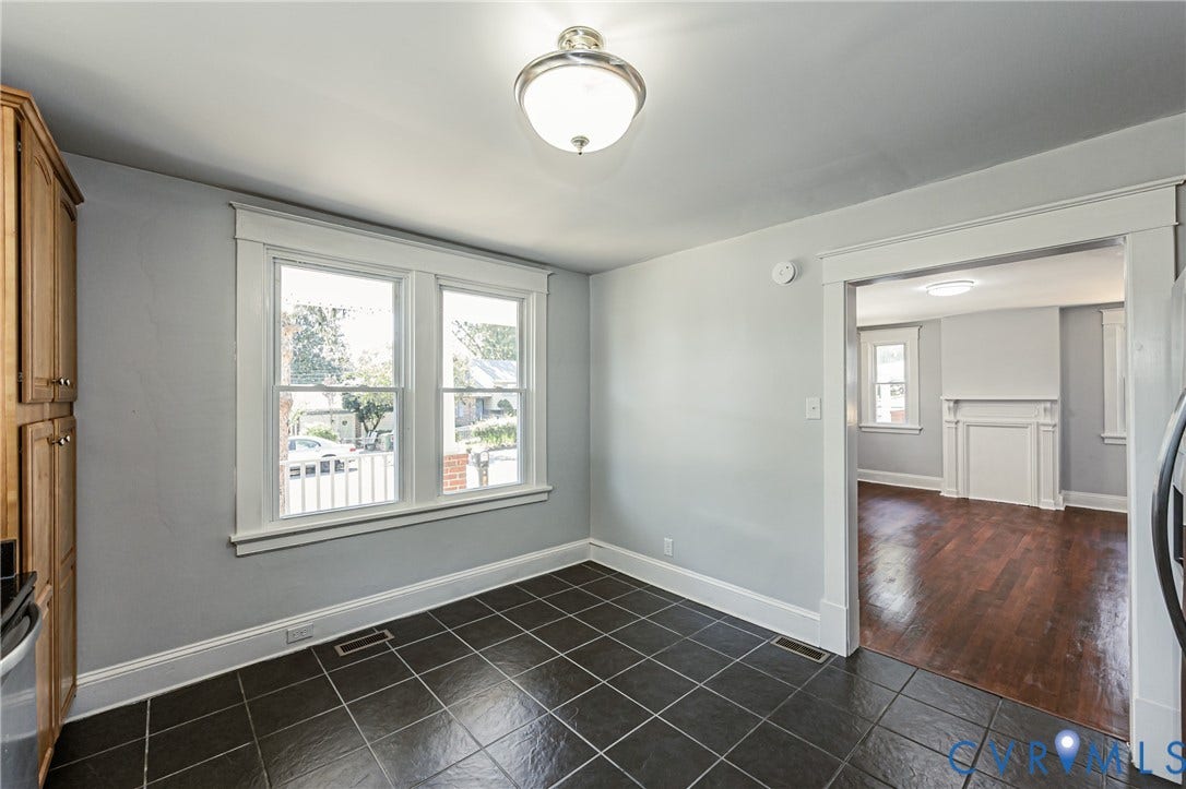 710 La Von Drive, Henrico, VA 23227 Tile flooring, built-in wooden cabinetry, double-hung windows with wide casing, and classic overhead lighting fixtures
