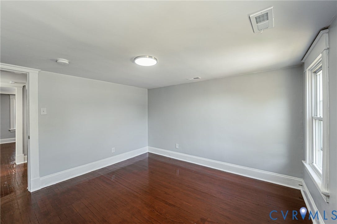 710 La Von Drive, Henrico, VA 23227 Interior room featuring wood-finish flooring, neutral wall paint, and a single-hung window with wide casing