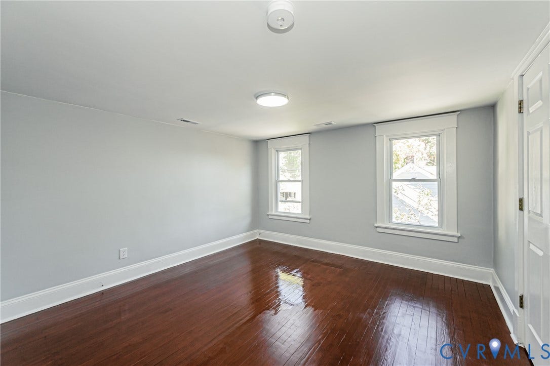 710 La Von Drive, Henrico, VA 23227 Room featuring wood-finish flooring, two double-hung windows with white trim, and ceiling-mounted lighting