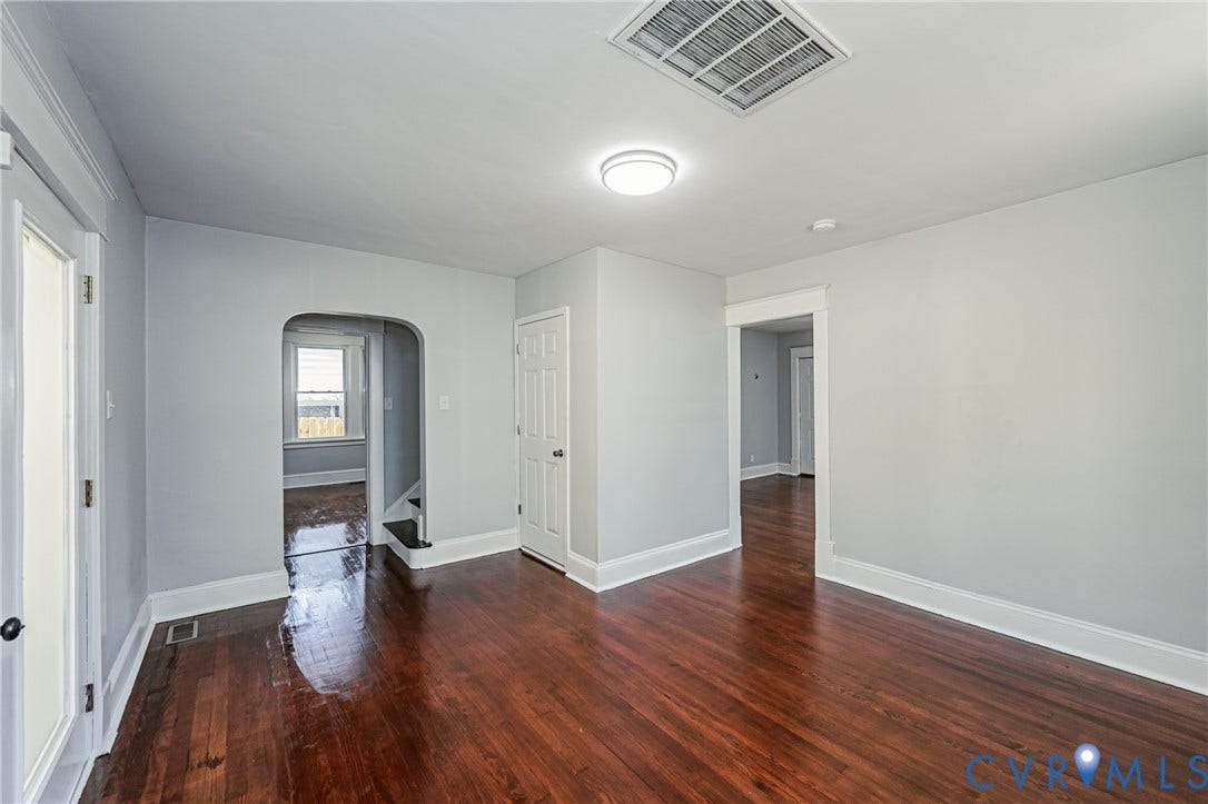 710 La Von Drive, Henrico, VA 23227 Interior space featuring wood-finish flooring, an arched entryway, and a multi-panel door