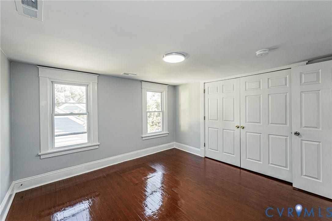 710 La Von Drive, Henrico, VA 23227 Interior space featuring wood-finish flooring, white six-panel closet doors, and windows framed by white millwork