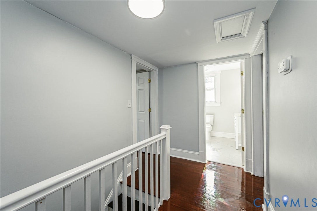 710 La Von Drive, Henrico, VA 23227 Hallway featuring polished wood-finish flooring, white wood railing, six-panel interior doors, and a flush-mount overhead light fixture