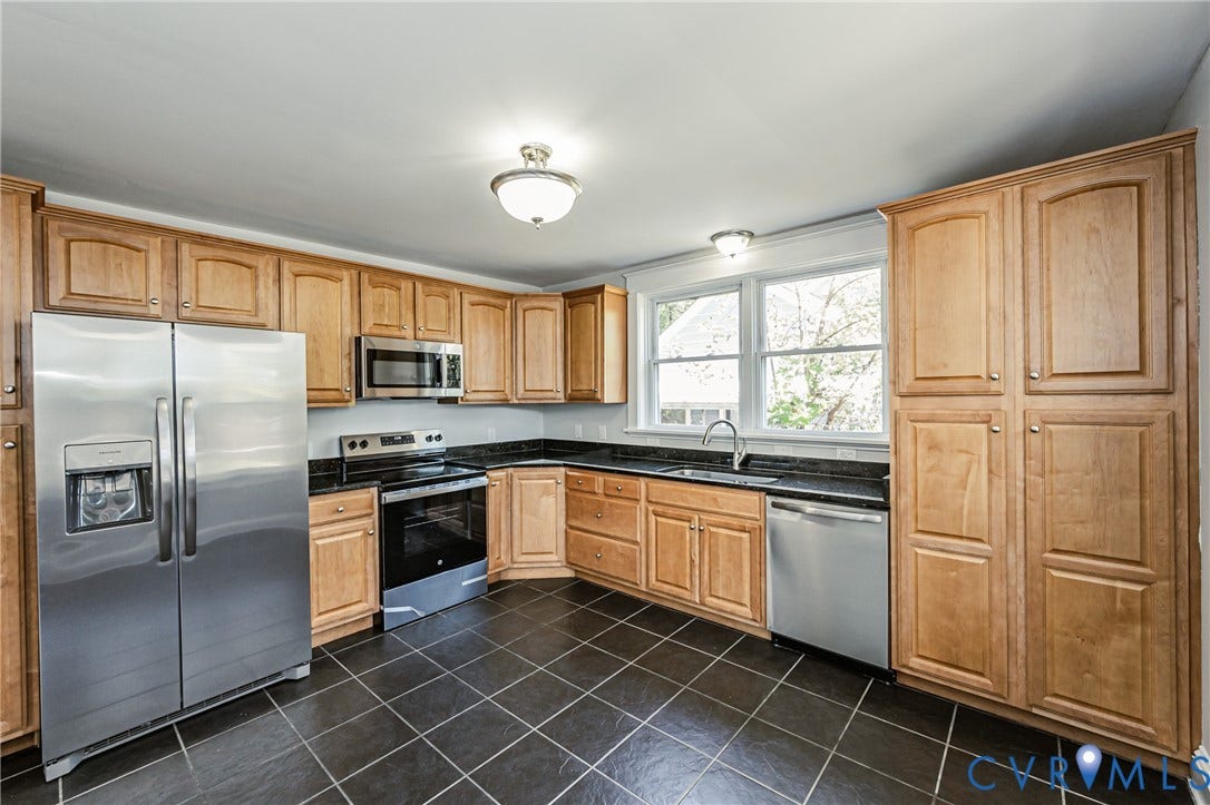 710 La Von Drive, Henrico, VA 23227 Kitchen featuring light wood cabinetry, dark stone countertops, stainless steel appliances, and dark tile flooring