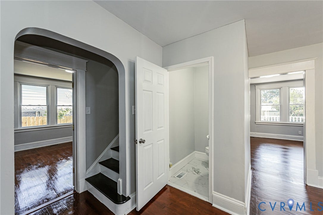 710 La Von Drive, Henrico, VA 23227 Arched entryway, solid wood-finish flooring, and multi-panel interior door with a classic white finish