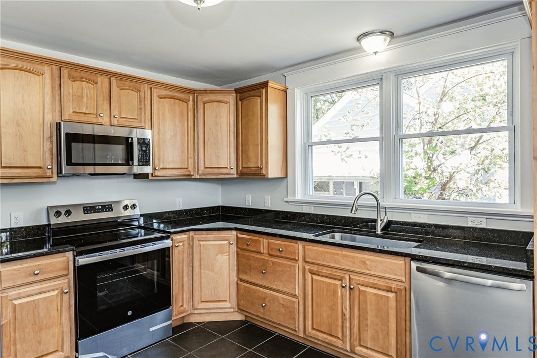 710 La Von Drive, Henrico, VA 23227 Kitchen featuring natural wood-finish cabinetry, dark solid-surface countertops, stainless steel appliances, a deep undermount sink with a gooseneck faucet, and tiled flooring