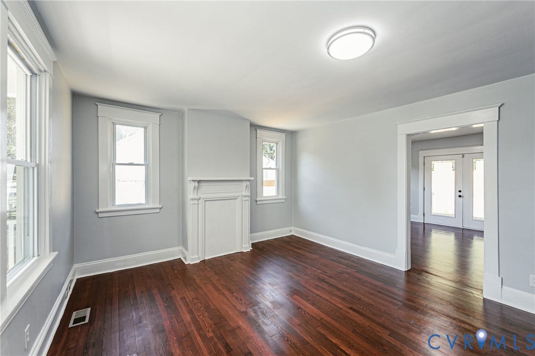 710 La Von Drive, Henrico, VA 23227 Interior space featuring wood-finish flooring, a decorative fireplace mantel, white window casings, and a double-door entrance with glass inserts