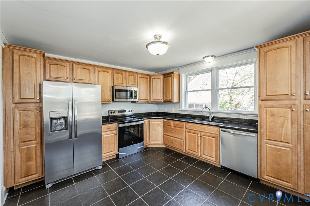 710 La Von Drive, Henrico, VA 23227 Kitchen featuring light-finish cabinetry, dark stone countertops, stainless steel appliances, tile flooring, and a double-basin sink