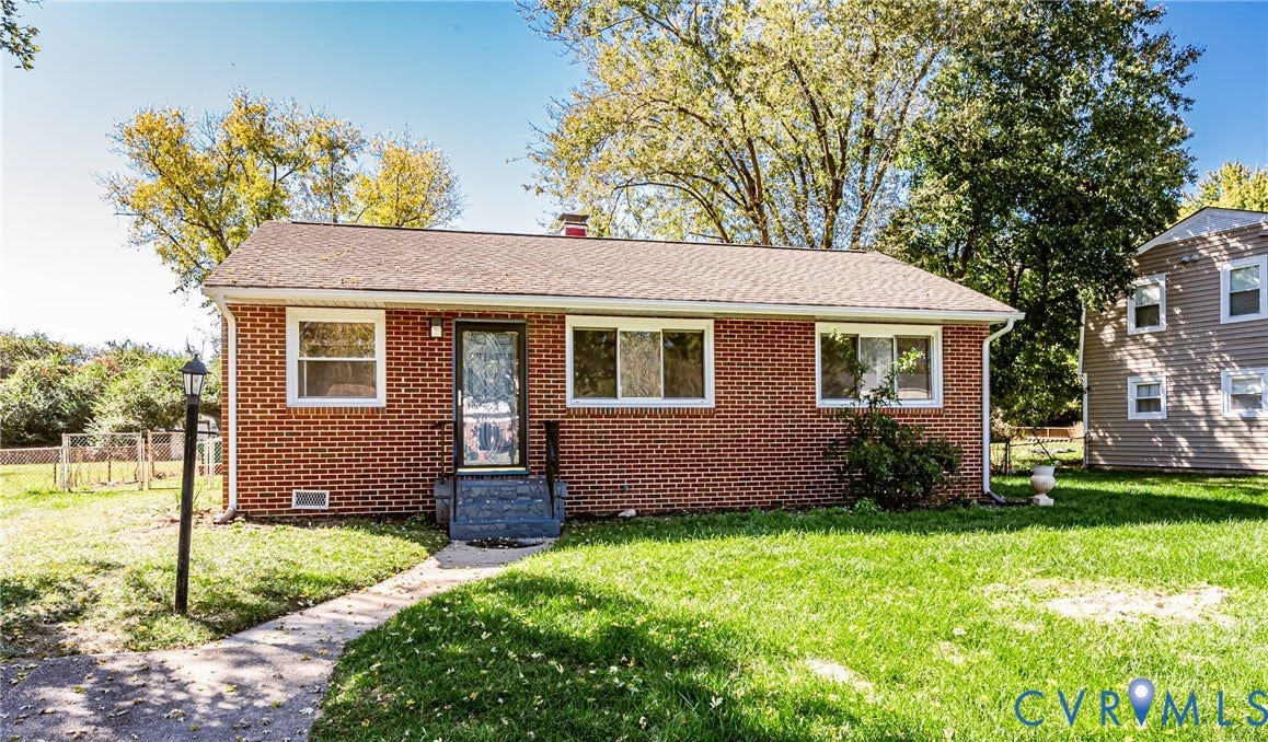 506 Meadowspring Road, Henrico, VA 23223 Single-story brick exterior with a gable roof, integrated chimney, multi-pane windows, and a paved walkway