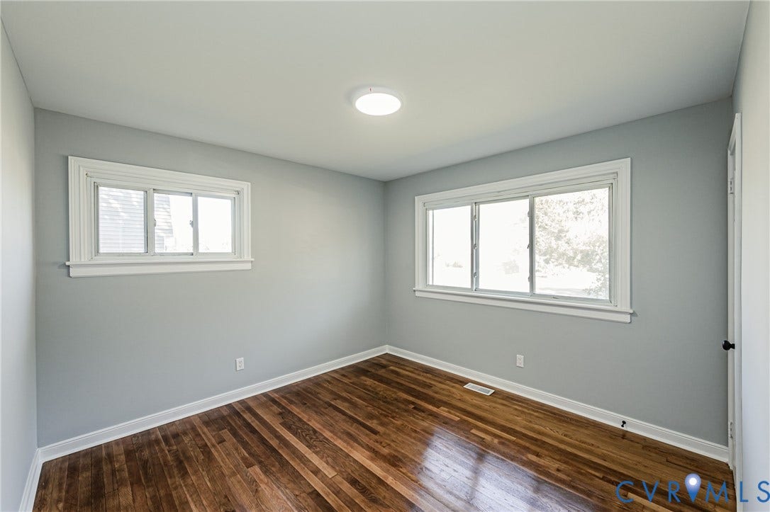 506 Meadowspring Road, Henrico, VA 23223 Room featuring wood-finish flooring, dual windows with white trim, and a flush-mount ceiling light fixture