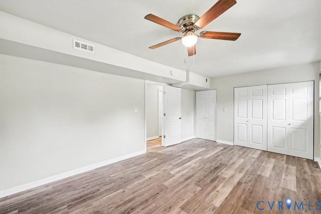 9737 Graves Road, South Chesterfield, VA 23803 Room featuring wood-finish flooring, a ceiling fan with integrated lighting, and dual sets of white panel doors