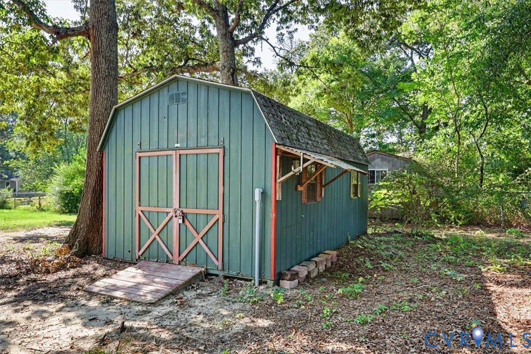 9737 Graves Road, South Chesterfield, VA 23803 Exterior storage structure with a gambrel roof, metal siding, double-door entry, and a wood-slat ramp