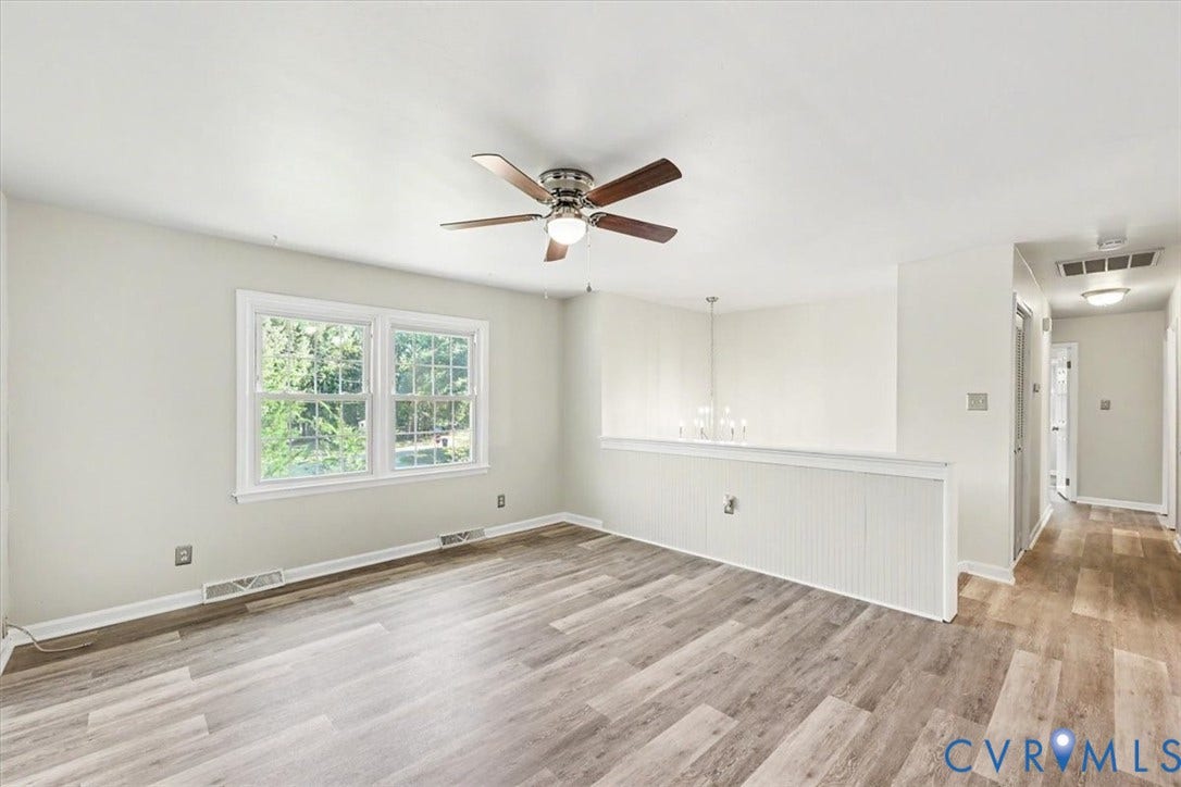 9737 Graves Road, South Chesterfield, VA 23803 Neutral interior featuring wood-finish flooring, a multi-blade ceiling fan with integrated lighting, beadboard wainscoting, and large double-pane windows