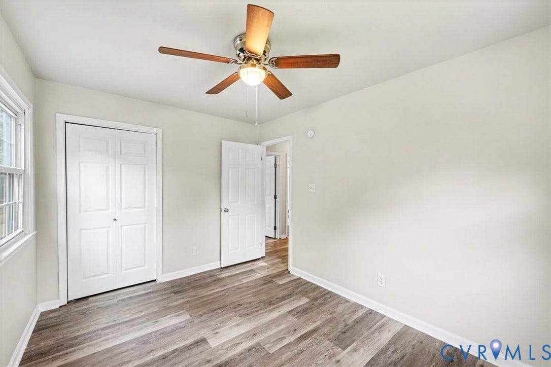 9737 Graves Road, South Chesterfield, VA 23803 Room featuring wood-finish flooring, a central ceiling fan with integrated lighting, and white six-panel closet doors