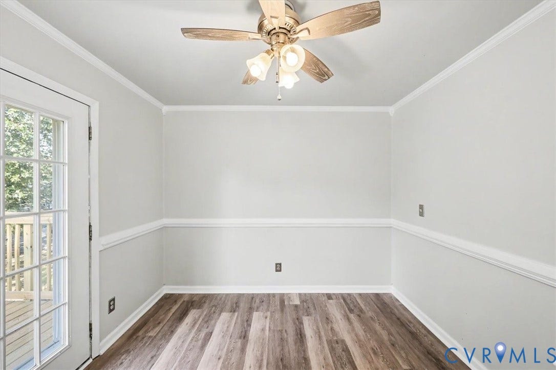 9737 Graves Road, South Chesterfield, VA 23803 Interior space featuring wood-finish flooring, chair rail molding, a glass-paneled exterior door, and a three-light ceiling fan