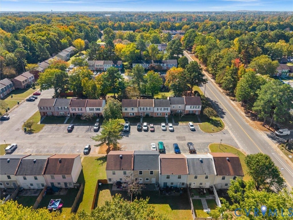 406 Alamosa Drive, Henrico, VA 23075 Aerial perspective of townhome community featuring multi-story brick and siding facades, asphalt parking areas, and manicured green space with mature trees