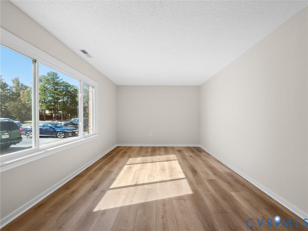 406 Alamosa Drive, Henrico, VA 23075 Interior room featuring wood-finish flooring, neutral wall tones, and a large horizontal window