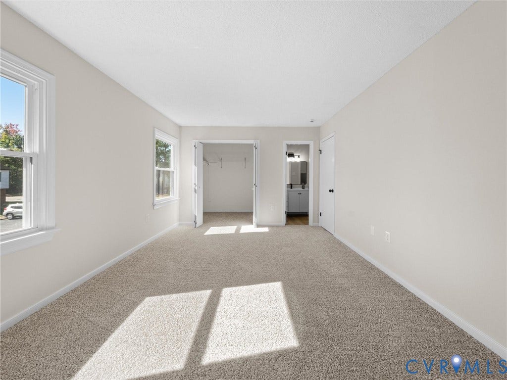 406 Alamosa Drive, Henrico, VA 23075 Neutral-toned interior space featuring wall-to-wall carpeting, dual-pane windows, a reach-in closet with double doors, and a solid-core interior door