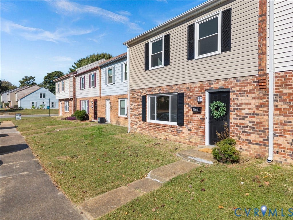 406 Alamosa Drive, Henrico, VA 23075 Exterior facade featuring a combination of brick masonry and horizontal siding, accented by black window shutters and a solid black entry door