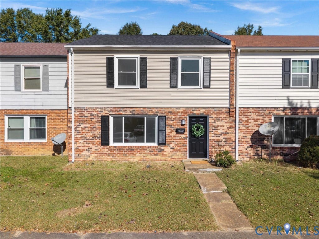 406 Alamosa Drive, Henrico, VA 23075 Two-story residence featuring a brick and horizontal siding exterior, dark-toned shutters, a gabled roofline, and a concrete walkway