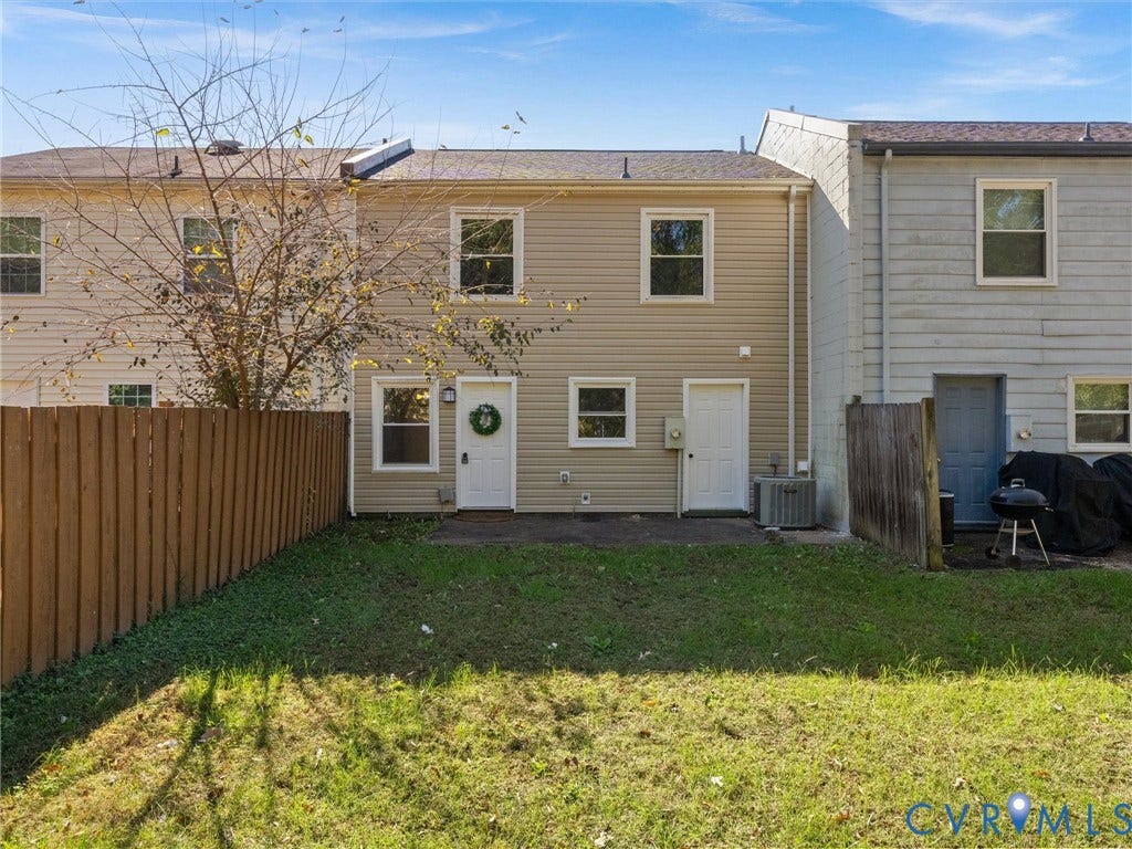 406 Alamosa Drive, Henrico, VA 23075 Rear exterior featuring tan siding, a private fenced yard, a concrete patio, and exterior light fixtures