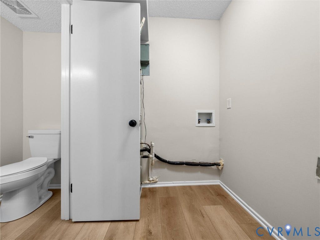406 Alamosa Drive, Henrico, VA 23075 Ceramic toilet, wood-finish flooring, and recessed laundry hookups