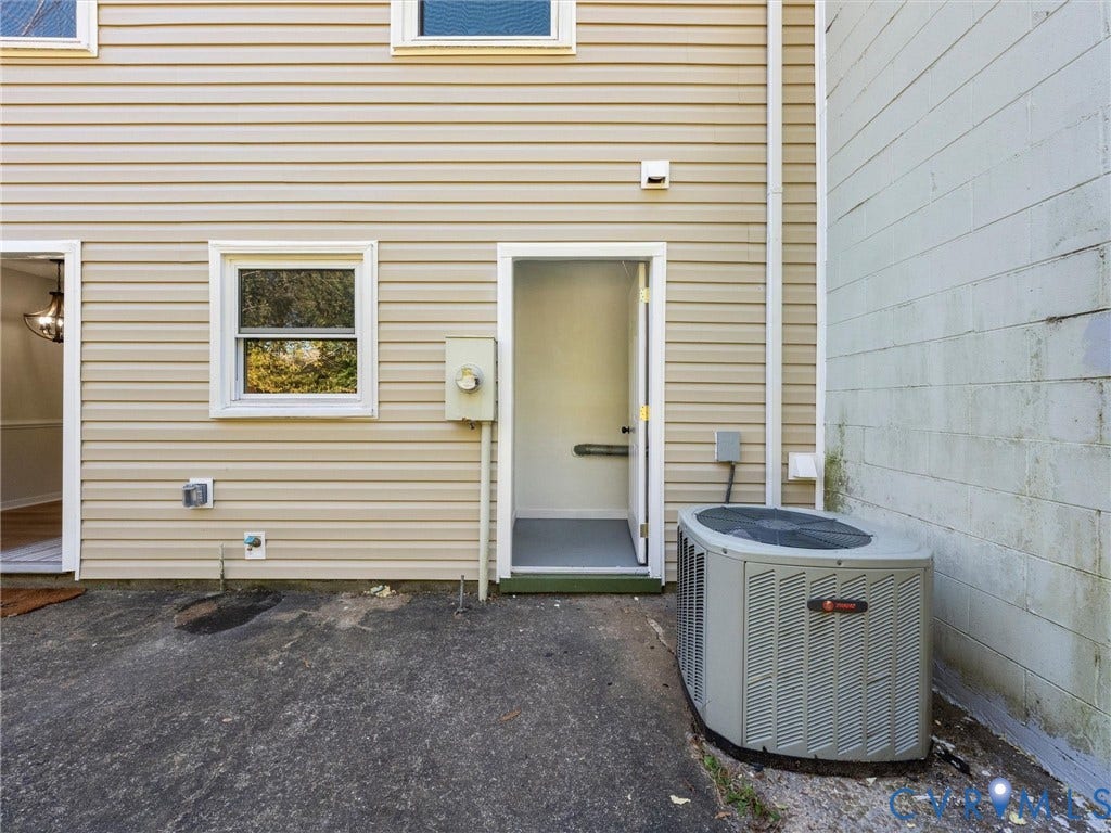 406 Alamosa Drive, Henrico, VA 23075 Exterior elevation featuring light-colored horizontal siding, single-hung window, dedicated outdoor storage entry, and exterior HVAC condenser unit