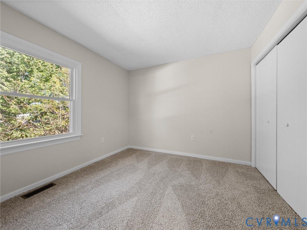 406 Alamosa Drive, Henrico, VA 23075 Neutral-toned wall-to-wall carpeting, double-panel closet doors, and single-hung window with exterior greenery