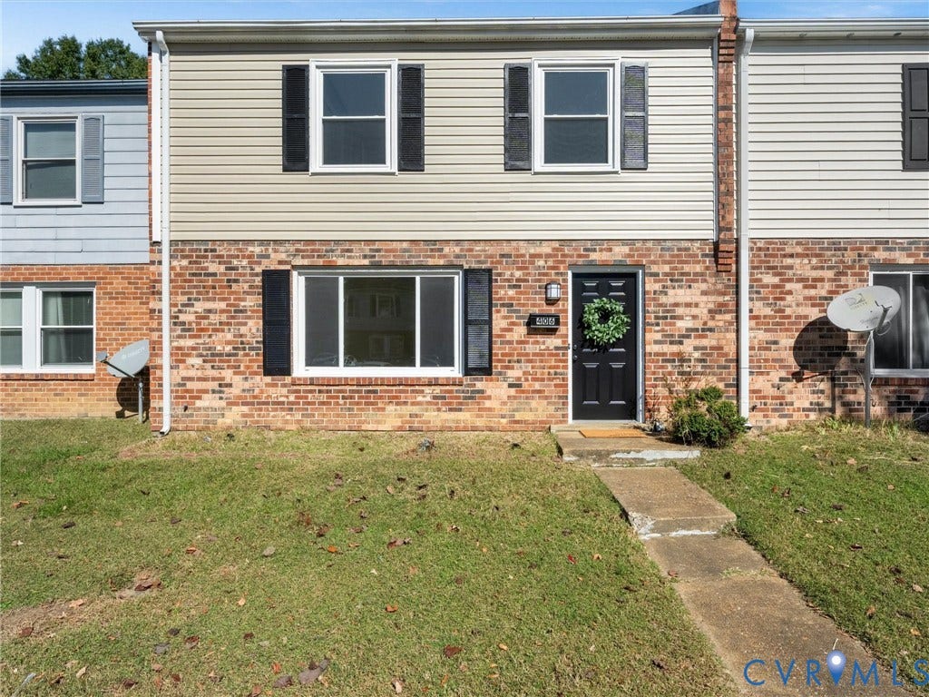 406 Alamosa Drive, Henrico, VA 23075 Two-story exterior featuring a combination of brick and vinyl siding, horizontal window shutters, and a concrete walkway